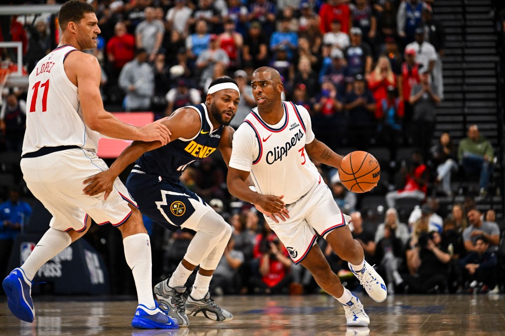 Los Angeles Clippers guard Chris Paul (3) moves the ball with center Brook Lopez (11) against Denver Nuggets guard Bruce Brown (11) during the second period at Intuit Dome.