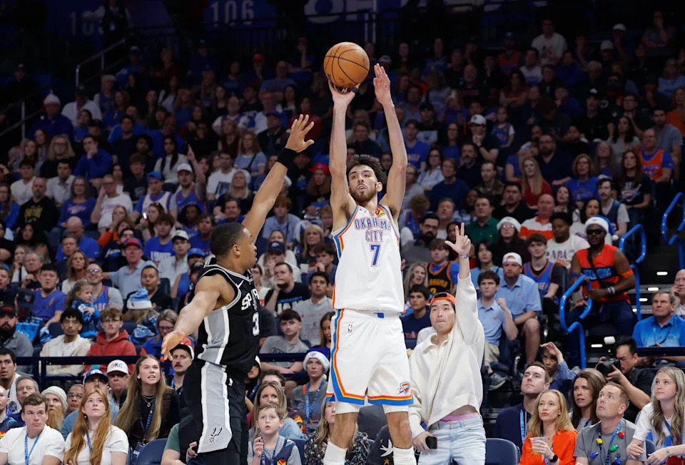 Dec 25, 2025; Oklahoma City, Oklahoma, USA; Oklahoma City Thunder center Chet Holmgren (7) shoots a three point basket as San Antonio Spurs forward Keldon Johnson (3) defends during the second half at Paycom Center. Mandatory Credit: Alonzo Adams-Imagn Images
