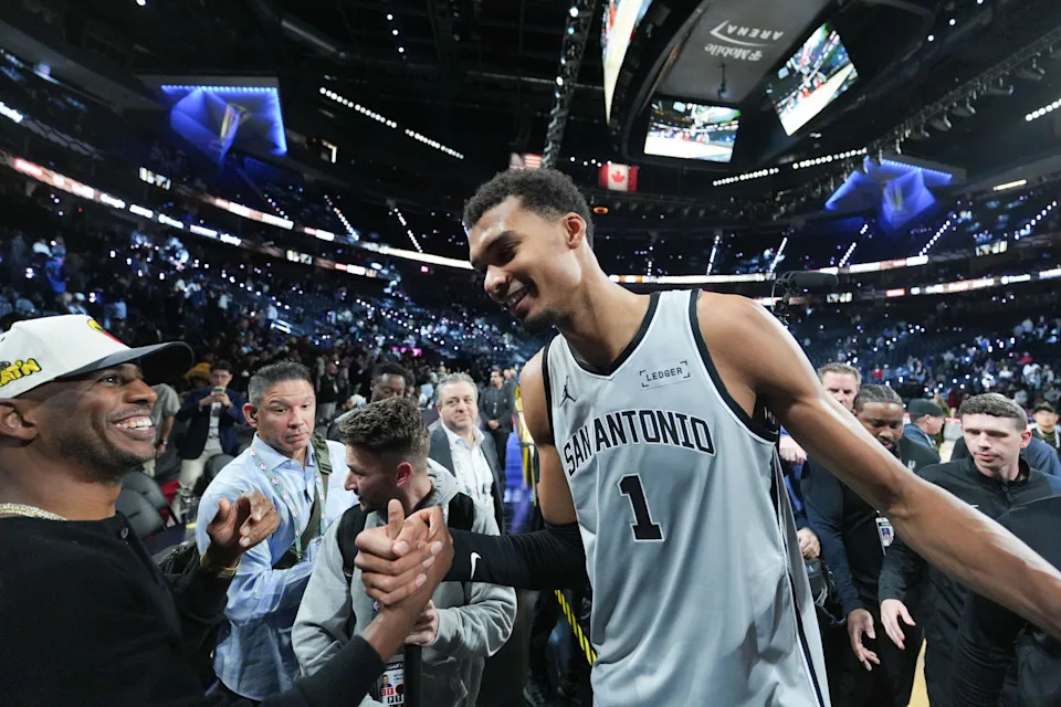 Dec 13, 2025; Las Vegas, Nevada, USA; San Antonio Spurs forward Victor Wembanyama (1) celebrates with Chris Paul after the game against the Oklahoma City Thunder at T-Mobile Arena. Mandatory Credit: Kirby Lee-Imagn Images