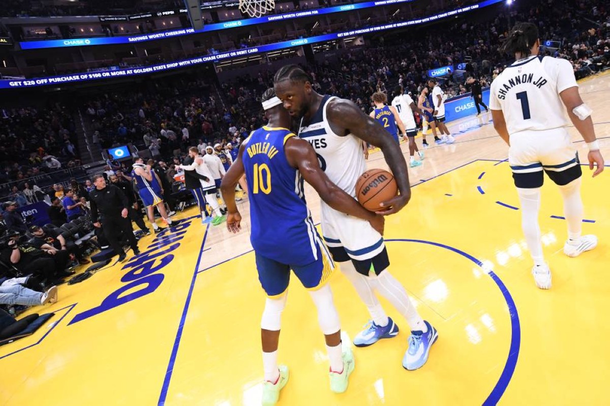 SAN FRANCISCO, CA - DECEMBER 12: Jimmy Butler #10 of the Golden State Warriors & Julius Randle #30 of the Minnesota Timberwolves hug after the game on December 12, 2025 at Chase Center in San Francisco, California. — AFP
