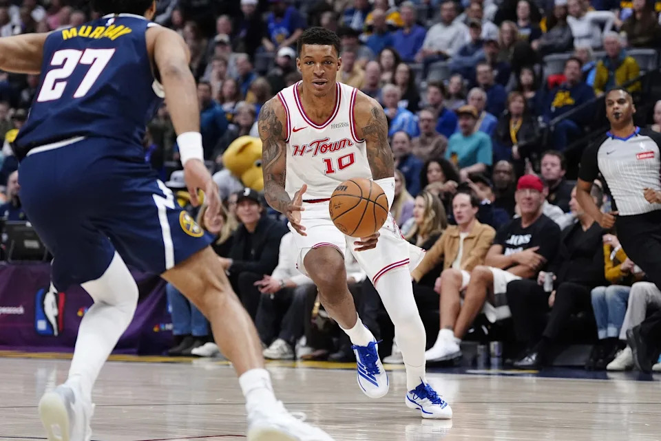 Dec 15, 2025; Denver, Colorado, USA; Houston Rockets forward Jabari Smith Jr. (10) controls the ball in the first quarter against the Denver Nuggets at Ball Arena. Mandatory Credit: Ron Chenoy-Imagn Images
