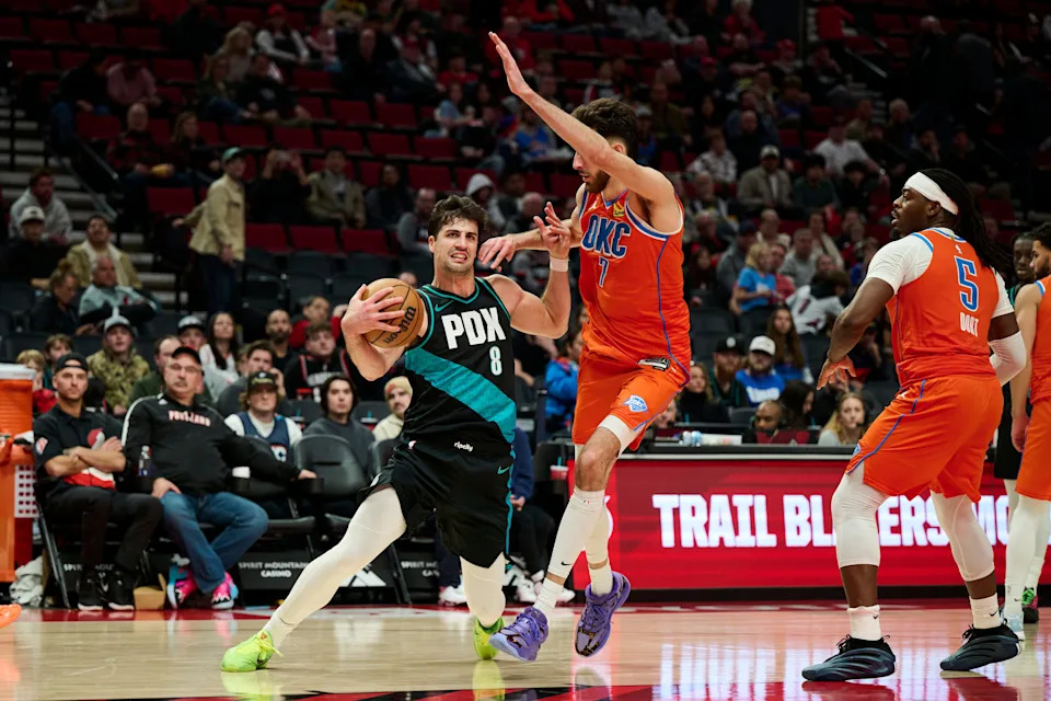 Nov 30, 2025; Portland, Oregon, USA; Portland Trail Blazers forward Deni Avdija (8) is fouled by Oklahoma City Thunder center Chet Holmgren (7) during the second half at Moda Center. Mandatory Credit: Troy Wayrynen-Imagn Images