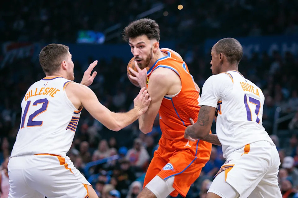 OKLAHOMA CITY, OKLAHOMA - DECEMBER 10: Chet Holmgren #7 of the Oklahoma City Thunder is double-teamed by Collin Gillespie #12 and Jamaree Bouyea #17 of the Phoenix Suns during the first half of the Emirates NBA Cup - Quarterfinals game at Paycom Center on December 10, 2025 in Oklahoma City, Oklahoma. NOTE TO USER: User expressly acknowledges and agrees that, by downloading and or using this photograph, User is consenting to the terms and conditions of the Getty Images License Agreement. (Photo by William Purnell/Getty Images)
