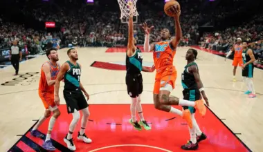 Jalen Williams of the Oklahoma City Thunder driving to the basket against Shaedon Sharpe of the Portland Trail Blazers during the first half of the Thunder's 123-115 NBA win at Moda Center on November 30, 2025, in Portland, Oregon.
