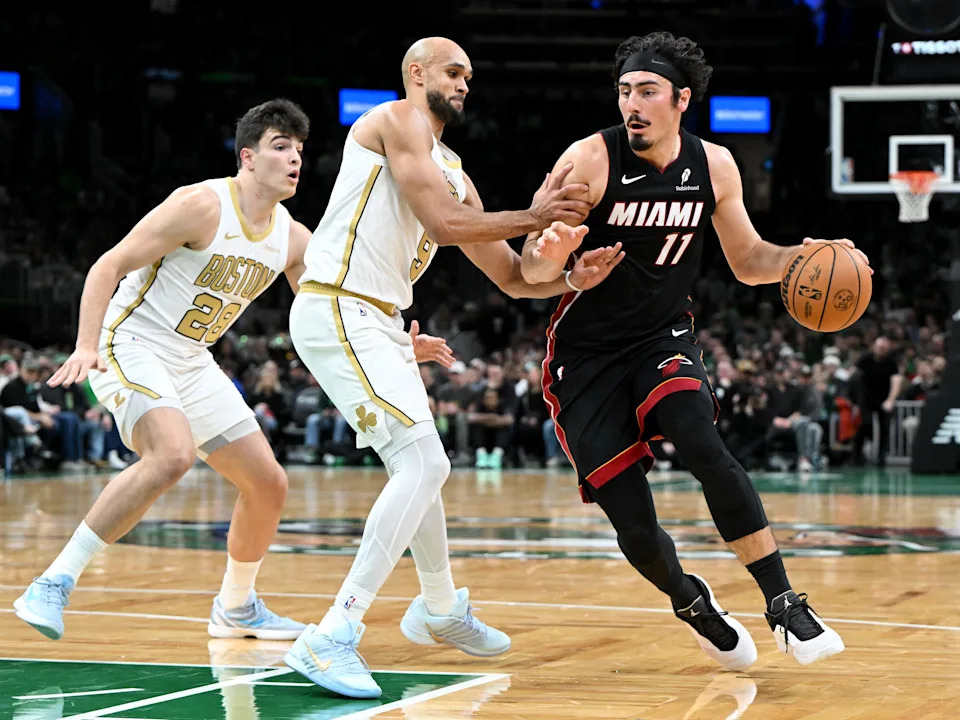 BOSTON, MASSACHUSETTS - DECEMBER 19: Jaime Jaquez Jr. #11 of the Miami Heat drives to the basket against Hugo Gonzalez #28 and Derrick White #9 of the Boston Celtics during the first half at TD Garden on December 19, 2025 in Boston, Massachusetts. NOTE TO USER: User expressly acknowledges and agrees that, by downloading and or using this photograph, User is consenting to the terms and conditions of the Getty Images License Agreement. (Photo by Brian Fluharty/Getty Images)