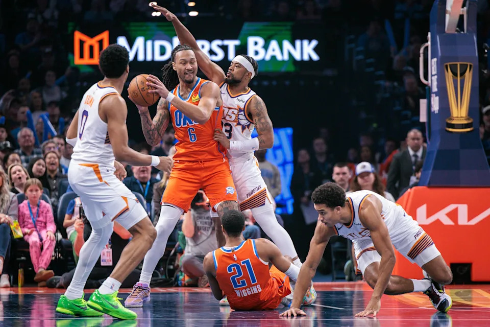 OKLAHOMA CITY, OKLAHOMA - DECEMBER 10: Jaylin Williams #6 of the Oklahoma City Thunder[ protects the ball from Jordan Goodwin #23 of the Phoenix Suns during the first half of the Emirates NBA Cup - Quarterfinals game at Paycom Center on December 10, 2025 in Oklahoma City, Oklahoma. NOTE TO USER: User expressly acknowledges and agrees that, by downloading and or using this photograph, User is consenting to the terms and conditions of the Getty Images License Agreement. (Photo by William Purnell/Getty Images)