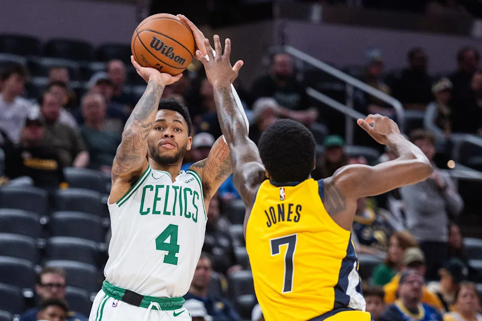 Dec 26, 2025; Indianapolis, Indiana, USA; Boston Celtics guard Anfernee Simons (4) shoots the ball while Indiana Pacers guard Kam Jones (7) defends in the second half at Gainbridge Fieldhouse. Mandatory Credit: Trevor Ruszkowski-Imagn Images