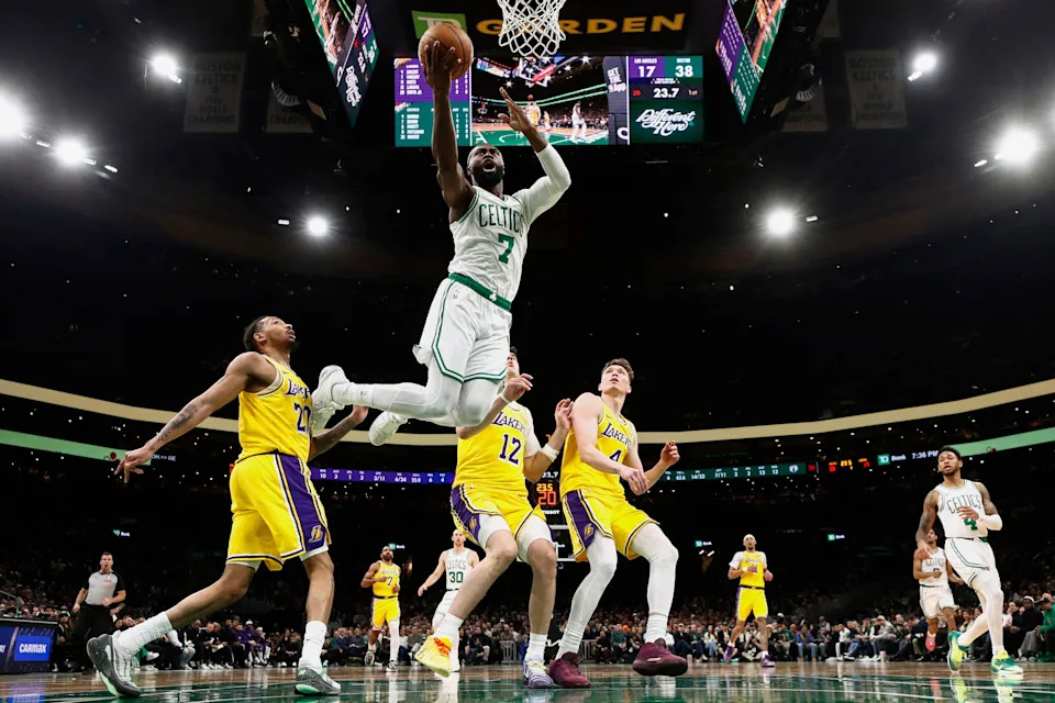 Dec 5, 2025; Boston, Massachusetts, USA; As three Los Angeles Laker defenders look on, Boston Celtics guard Jaylen Brown (7) goes to the basket during the first half at TD Garden. Mandatory Credit: Winslow Townson-Imagn Images