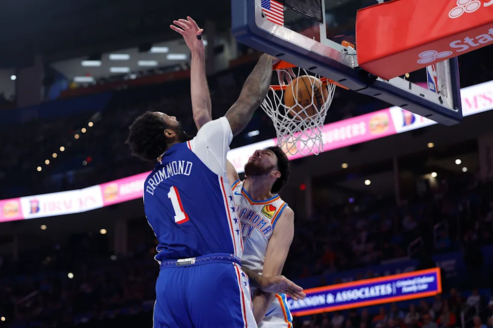 Dec 28, 2025; Oklahoma City, Oklahoma, USA; Philadelphia 76ers center Andre Drummond (1) dunks over Oklahoma City Thunder center Chet Holmgren (7) during the second quarter at Paycom Center. Mandatory Credit: Alonzo Adams-Imagn Images