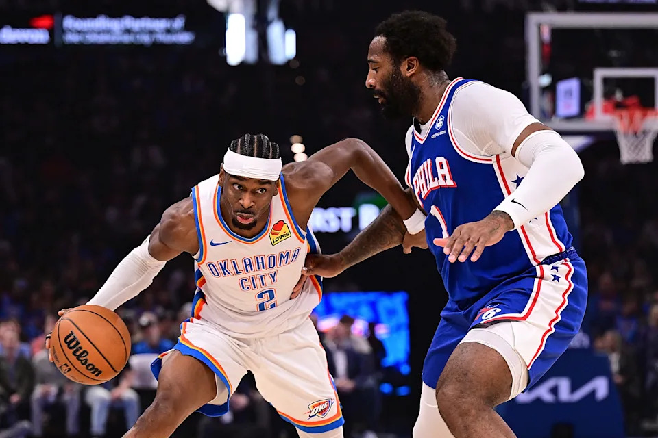 OKLAHOMA CITY, OKLAHOMA - DECEMBER 28: Shai Gilgeous-Alexander #2 of the Oklahoma City Thunder attempts to moves the ball past Andre Drummond #1 of the Philadelphia 76ers during the first half at Paycom Center on December 28, 2025 in Oklahoma City, Oklahoma. NOTE TO USER: User expressly acknowledges and agrees that, by downloading and or using this photograph, User is consenting to the terms and conditions of the Getty Images License Agreement. (Photo by Joshua Gateley/Getty Images)