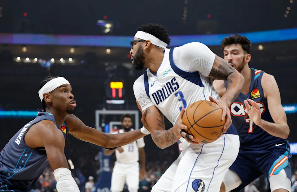 Dec 5, 2025; Oklahoma City, Oklahoma, USA; Dallas Mavericks forward Anthony Davis (3) is defended by Oklahoma City Thunder guard Shai Gilgeous-Alexander (2) and center Chet Holmgren (7) during the first quarter at Paycom Center. Mandatory Credit: Alonzo Adams-Imagn Images