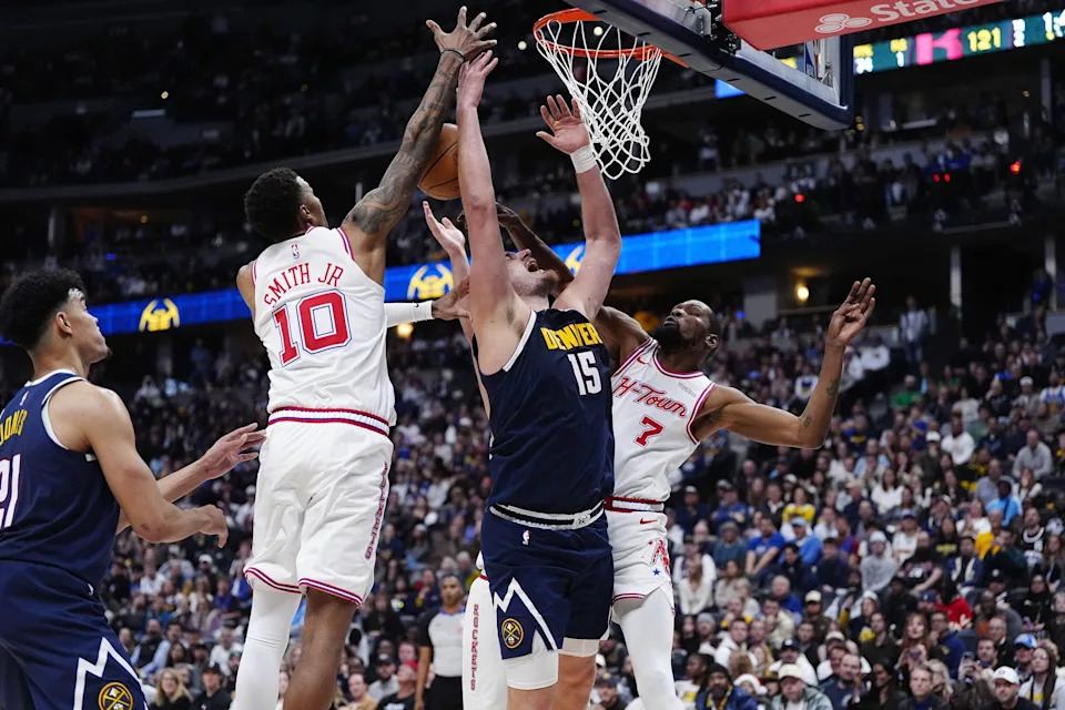 Dec 15, 2025; Denver, Colorado, USA; Houston Rockets forward Jabari Smith Jr. (10) and forward Kevin Durant (7) defend on Denver Nuggets center Nikola Jokic (15) in overtime at Ball Arena. Mandatory Credit: Ron Chenoy-Imagn Images