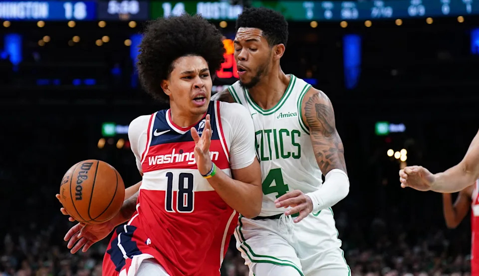 Nov 5, 2025; Boston, Massachusetts, USA; Washington Wizards forward Kyshawn George (18) drives the ball against Boston Celtics guard Anfernee Simons (4) in the first quarter at TD Garden. Mandatory Credit: David Butler II-Imagn Images