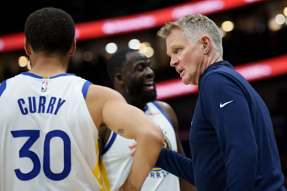 Golden State Warriors coach Steve Kerr talks to guard Stephen Curry and forward Draymond Green during the first half of a Nov. 16 game against the New Orleans Pelicans.