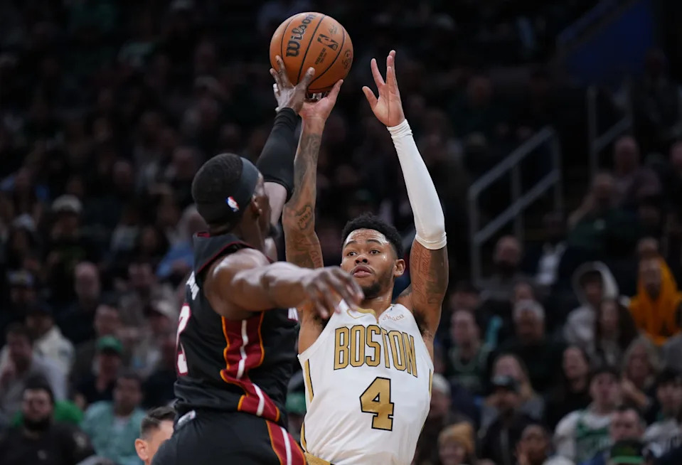 Dec 19, 2025; Boston, Massachusetts, USA; Boston Celtics guard Anfernee Simons (4) shoots the ball against Miami Heat center Bam Adebayo (13) in the second half at TD Garden. Mandatory Credit: David Butler II-Imagn Images