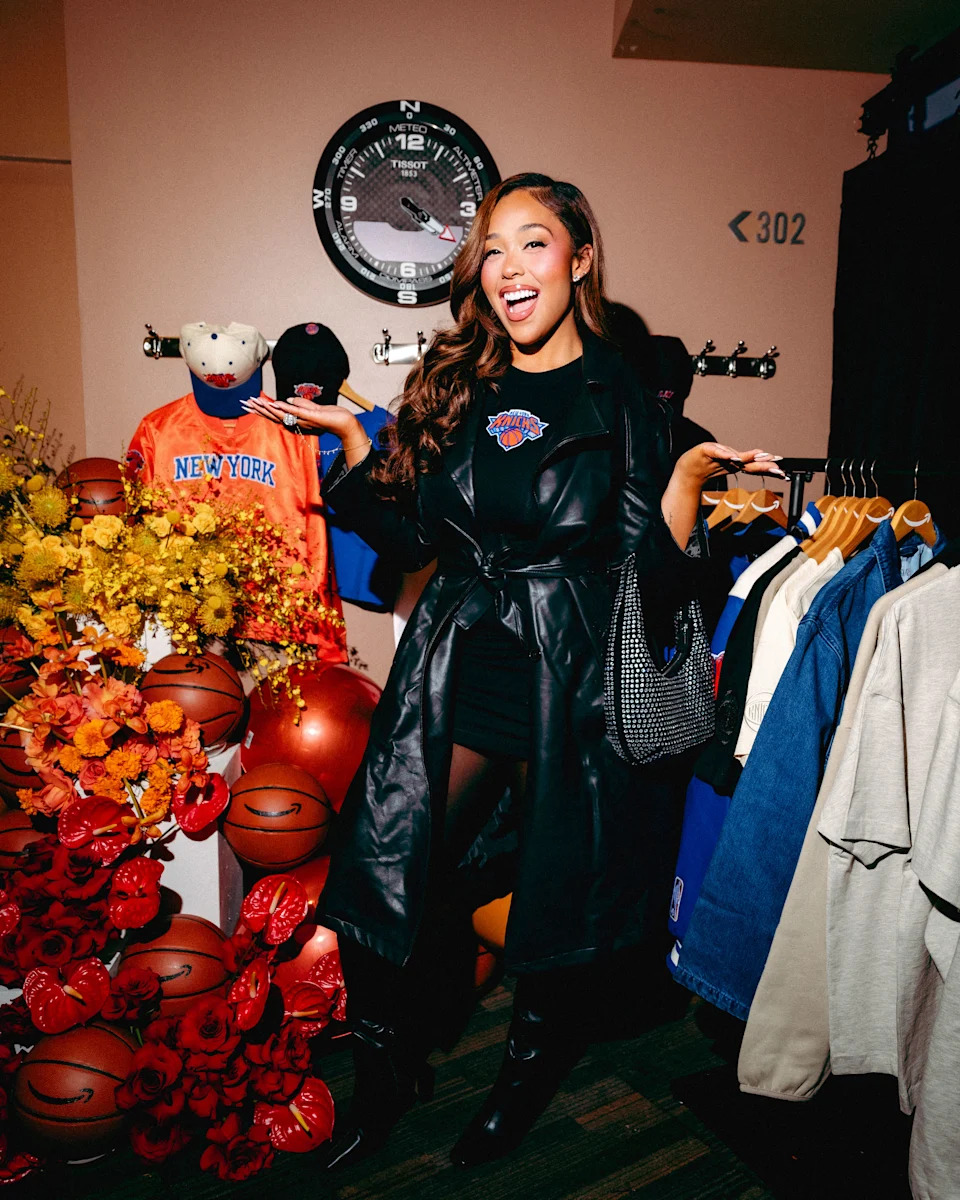 jordyn woods smiling while wearing nicks merch and standing amidst a curated selection of amazon sports goods