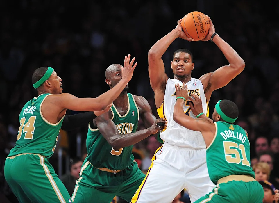 March 11, 2012; Los Angeles, CA, USA; Los Angeles Lakers center Andrew Bynum (17) controls the ball against the defense of Boston Celtics small forward Paul Pierce (34), power forward Kevin Garnett (5) and point guard Keyon Dooling (51) during the first half at Staples Center. Mandatory Credit: Gary A. Vasquez-USA TODAY Sports