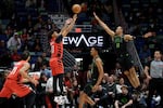 Portland Trail Blazers guard Shaedon Sharpe (17) attempts a three point basket against New Orleans Pelicans guard Bryce McGowens (11) during the first half of an NBA basketball game in New Orleans, Thursday, Dec. 11, 2025.