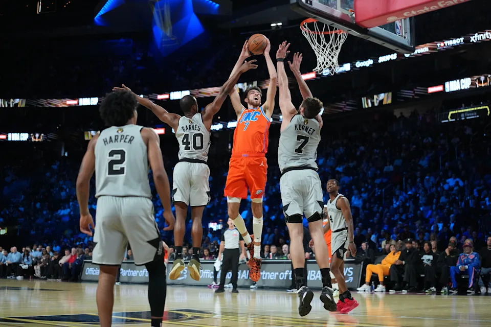 Dec 13, 2025; Las Vegas, Nevada, USA; Oklahoma City Thunder center Chet Holmgren (7) shoots over San Antonio Spurs forward Harrison Barnes (40) and center Luke Kornet (7) during the first quarter at T-Mobile Arena. Mandatory Credit: Kirby Lee-Imagn Images