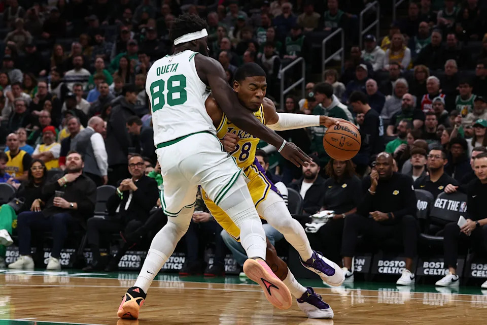 Dec 5, 2025; Boston, Massachusetts, USA; Los Angeles Lakers forward Rui Hachimura (28) drives on Boston Celtics center Neemias Queta (88) during the first quarter at TD Garden. Mandatory Credit: Winslow Townson-Imagn Images