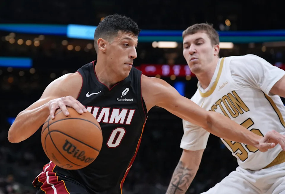 Dec 19, 2025; Boston, Massachusetts, USA; Miami Heat forward Simone Fontecchio (0) drives the ball against Boston Celtics guard Baylor Scheierman (55) in the second quarter at TD Garden. Mandatory Credit: David Butler II-Imagn Images