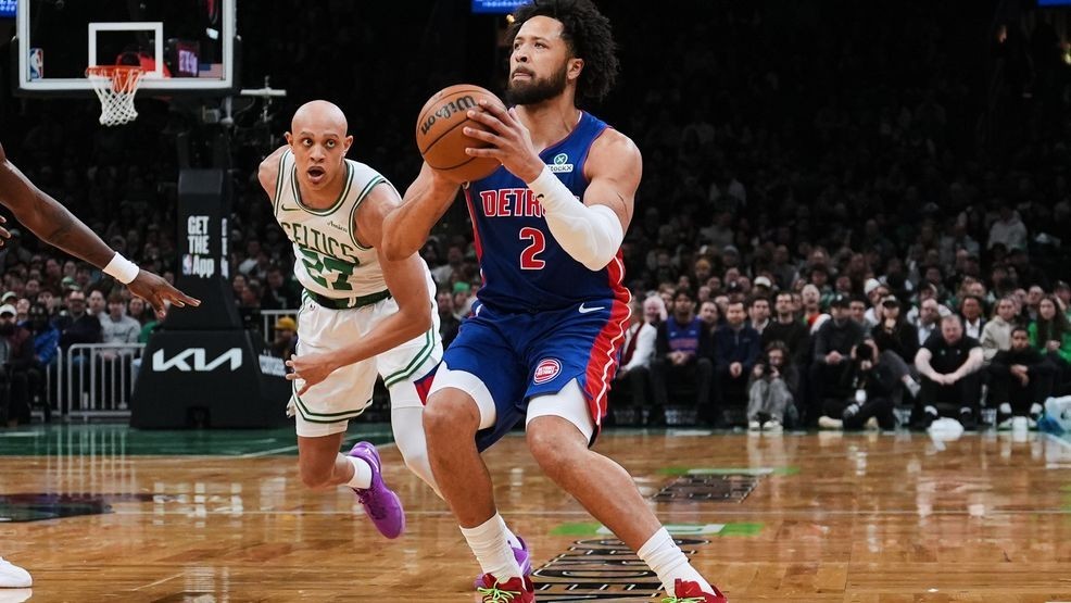 Detroit Pistons guard Cade Cunningham (2) lines up a 3-point shot against Boston Celtics guard Jordan Walsh (27) during the first half of an NBA basketball game, Monday, Dec. 15, 2025, in Boston. (AP Photo/Charles Krupa)