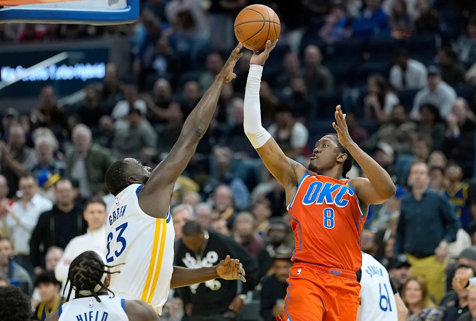 SAN FRANCISCO, CALIFORNIA - DECEMBER 02: Jalen Williams #8 of the Oklahoma City Thunder shoots and scores over Draymond Green #23 of the Golden State Warriors in the second half at Chase Center on December 02, 2025 in San Francisco, California. NOTE TO USER: User expressly acknowledges and agrees that, by downloading and or using this photograph, User is consenting to the terms and conditions of the Getty Images License Agreement. (Photo by Thearon W. Henderson/Getty Images)