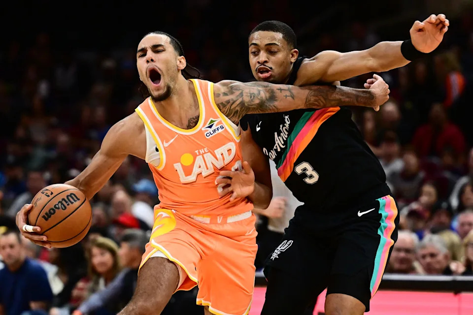 Cleveland Cavaliers guard Jaylon Tyson (20) drives to the basket as San Antonio Spurs forward Keldon Johnson (3) defends Dec. 5, 2025, in Cleveland.