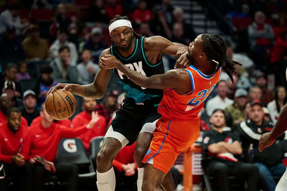 Nov 30, 2025; Portland, Oregon, USA; Portland Trail Blazers forward Jerami Grant (9) drives to the basket during the second half against Oklahoma City Thunder guard Cason Wallace (22) at Moda Center. Mandatory Credit: Troy Wayrynen-Imagn Images