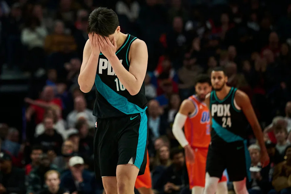 Nov 30, 2025; Portland, Oregon, USA; Portland Trail Blazers center Yang Hansen (16) reacts after missing a three point basket during the first half against the Oklahoma City Thunder at Moda Center. Mandatory Credit: Troy Wayrynen-Imagn Images
