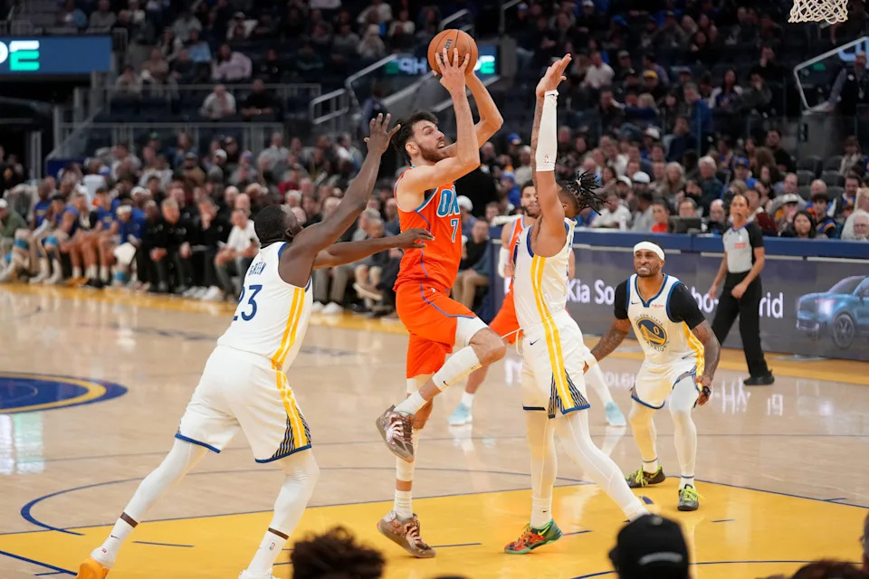 Dec 2, 2025; San Francisco, California, USA; Oklahoma City Thunder center Chet Holmgren (7) shoots the ball between Golden State Warriors forward Draymond Green (23) and guard Will Richard (3) in the third quarter at the Chase Center. Mandatory Credit: Cary Edmondson-Imagn Images
