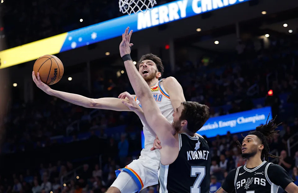Dec 25, 2025; Oklahoma City, Oklahoma, USA; Oklahoma City Thunder center Chet Holmgren (7) goes to the basket as San Antonio Spurs center Luke Kornet (7) defends during the second half at Paycom Center. Mandatory Credit: Alonzo Adams-Imagn Images