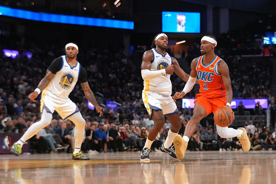 Dec 2, 2025; San Francisco, California, USA; Oklahoma City Thunder guard Shai Gilgeous-Alexander (2) dribbles the ball next to Golden State Warriors guard Buddy Hield (7) in the fourth quarter at the Chase Center. Mandatory Credit: Cary Edmondson-Imagn Images