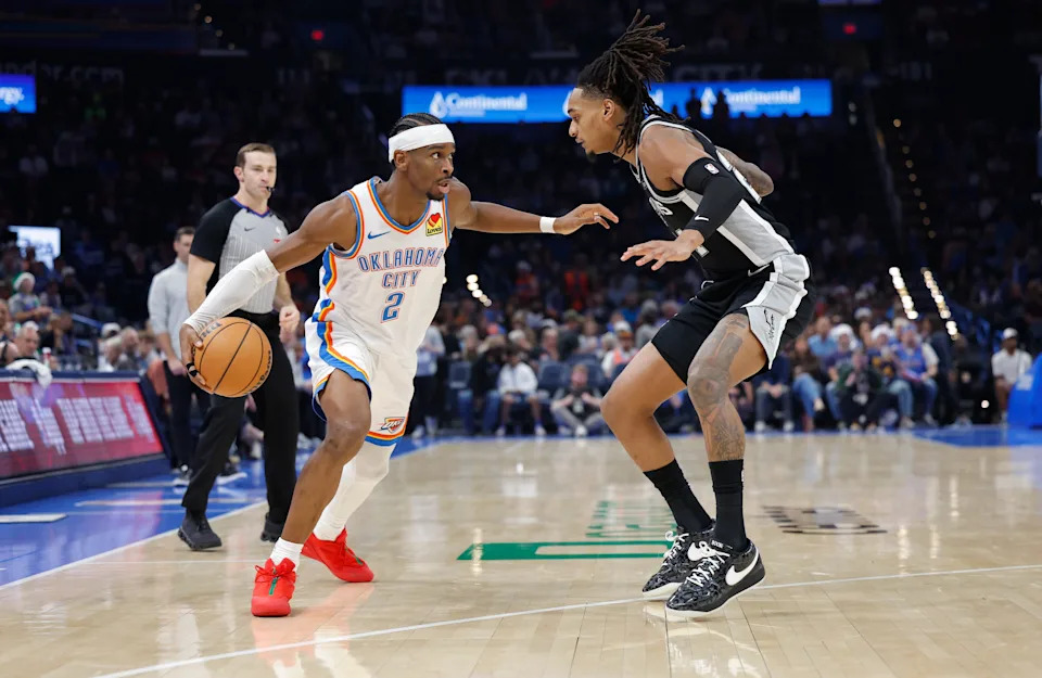 Dec 25, 2025; Oklahoma City, Oklahoma, USA; Oklahoma City Thunder guard Shai Gilgeous-Alexander (2) drives around San Antonio Spurs guard Stephon Castle (5) during the second half at Paycom Center. Mandatory Credit: Alonzo Adams-Imagn Images