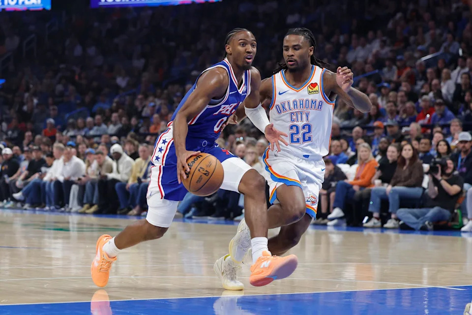 Dec 28, 2025; Oklahoma City, Oklahoma, USA; Philadelphia 76ers guard Tyrese Maxey (0) drives to the basket beside Oklahoma City Thunder guard Cason Wallace (22) during the first quarter at Paycom Center. Mandatory Credit: Alonzo Adams-Imagn Images