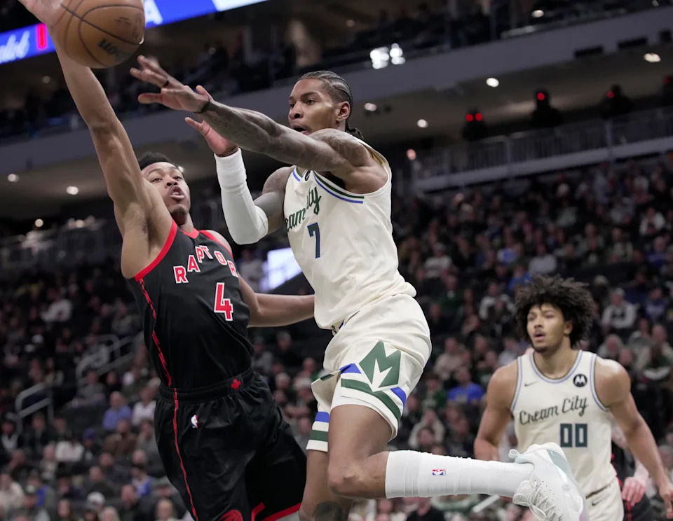 Milwaukee Bucks guard Kevin Porter Jr. (7) is guarded by Toronto Raptors forward Scottie Barnes (4) during the first half of their game Thursday, December 18, 2025 at Fiserv Forum in Milwaukee, Wisconsin.