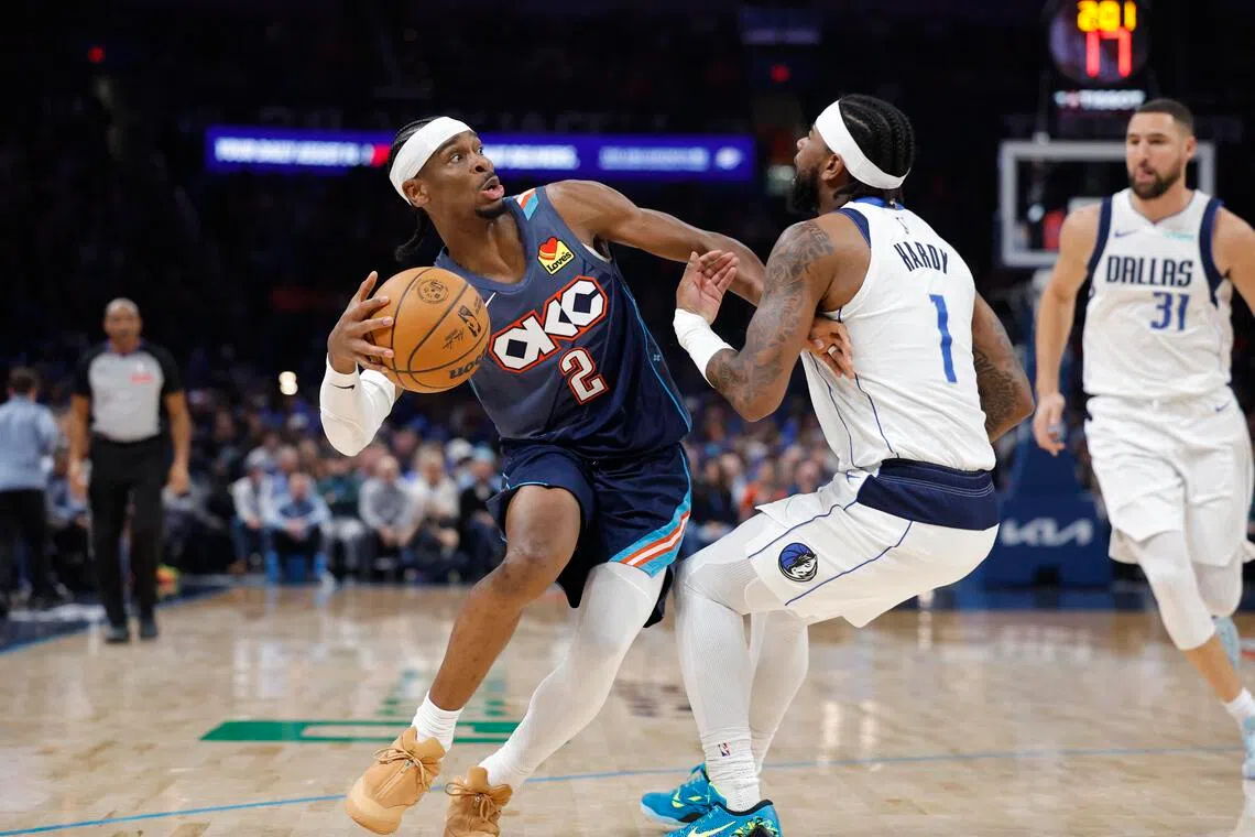 Oklahoma City Thunder guard Shai Gilgeous-Alexander moves the ball around Dallas Mavericks guard Jaden Hardy during the second half at Paycom Center.
