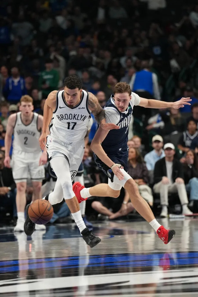 Michael Porter Jr. of the Brooklyn Nets and Cooper Flagg of the Dallas Mavericks battles for the ball during the game on December 12, 2025 at American Airlines Center in Dallas, Texas. NBAE via Getty Images