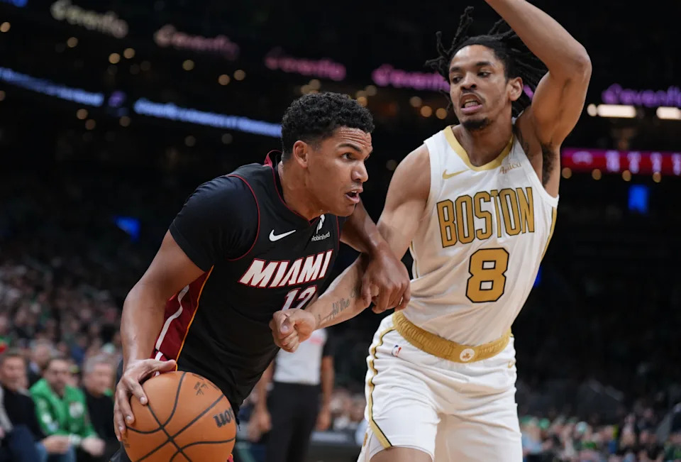 Dec 19, 2025; Boston, Massachusetts, USA; Miami Heat guard Dru Smith (12) drives the ball against Boston Celtics forward Josh Minott (8) in the first quarter at TD Garden. Mandatory Credit: David Butler II-Imagn Images