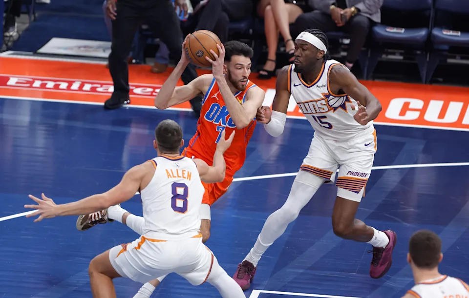 Dec 10, 2025; Oklahoma City, Oklahoma, USA; Oklahoma City Thunder center Chet Holmgren (7) drives between Phoenix Suns guard Grayson Allen (8) and Mark Williams (15) during the first quarter at Paycom Center. Mandatory Credit: Alonzo Adams-Imagn Images