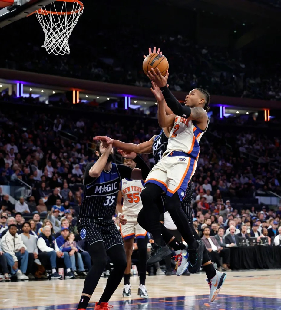 New York Knicks guard Miles McBride (R) puts up a shot past Orlando Magic center Goga Bitadze (L) in the second half at Madison Square Garden in New York, Sunday, December 7, 2025. JASON SZENES/ NY POST