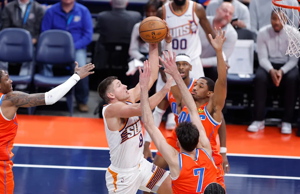 Dec 10, 2025; Oklahoma City, Oklahoma, USA; Oklahoma City Thunder guard Aaron Wiggins (21) blocks a shot by Phoenix Suns guard Grayson Allen (8) during the third quarter at Paycom Center. Mandatory Credit: Alonzo Adams-Imagn Images