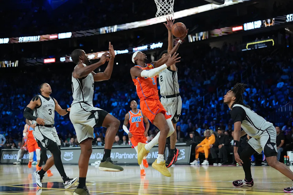 Dec 13, 2025; Las Vegas, Nevada, USA; Oklahoma City Thunder guard Shai Gilgeous-Alexander (2) goes to the basket as San Antonio Spurs guard Dylan Harper (2) defends during the first quarter at T-Mobile Arena. Mandatory Credit: Kirby Lee-Imagn Images