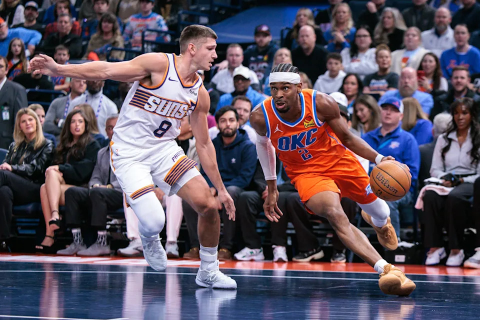 OKLAHOMA CITY, OKLAHOMA - DECEMBER 10: Shai Gilgeous-Alexander #2 of the Oklahoma City Thunder drives to the basket around Grayson Allen #8 of the Phoenix Suns during the first half of the Emirates NBA Cup - Quarterfinals game at Paycom Center on December 10, 2025 in Oklahoma City, Oklahoma. NOTE TO USER: User expressly acknowledges and agrees that, by downloading and or using this photograph, User is consenting to the terms and conditions of the Getty Images License Agreement. (Photo by William Purnell/Getty Images)