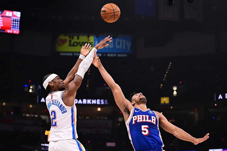 OKLAHOMA CITY, OKLAHOMA - DECEMBER 28: Shai Gilgeous-Alexander #2 of the Oklahoma City Thunder attempts a shot in front of Quentin Grimes #5 of the Philadelphia 76ers during the first half at Paycom Center on December 28, 2025 in Oklahoma City, Oklahoma. NOTE TO USER: User expressly acknowledges and agrees that, by downloading and or using this photograph, User is consenting to the terms and conditions of the Getty Images License Agreement. (Photo by Joshua Gateley/Getty Images)