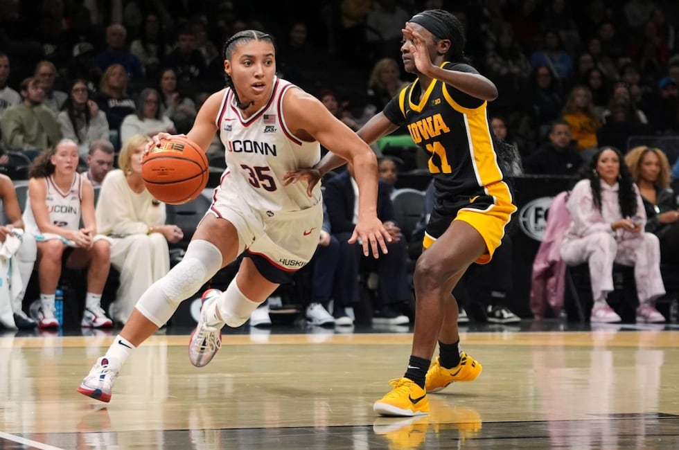 UConn's Azzi Fudd (35) drives past Iowa's Chazadi Wright (11) during the second half of an...