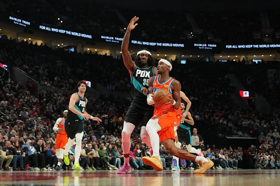PORTLAND, OREGON - NOVEMBER 30: Shai Gilgeous-Alexander #2 of the Oklahoma City Thunder goes to the basket under pressure from Robert Williams III #35 of the Portland Trail Blazers during the second half at Moda Center on November 30, 2025 in Portland, Oregon. NOTE TO USER: User expressly acknowledges and agrees that, by downloading and or using this photograph, User is consenting to the terms and conditions of the Getty Images License Agreement. (Photo by Soobum Im/Getty Images)