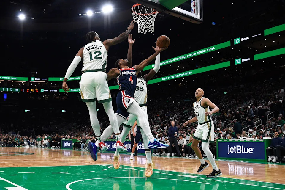 Apr 14, 2024; Boston, Massachusetts, USA; Washington Wizards guard Jared Butler (4) drives to the basket between Boston Celtics center Neemias Queta (88) and forward Oshae Brissett (12) during the first half at TD Garden. Mandatory Credit: Bob DeChiara-USA TODAY Sports