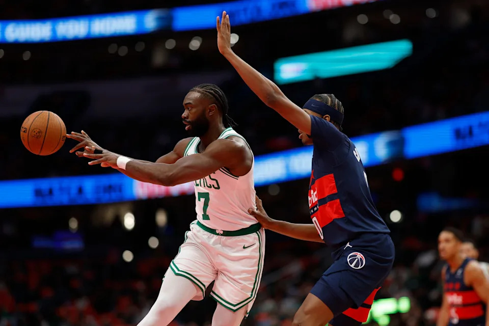 Nov 22, 2024; Washington, District of Columbia, USA; Boston Celtics guard Jaylen Brown (7) passes the ball as Washington Wizards guard Bilal Coulibaly (0) deforms in the first half at Capital One Arena. Mandatory Credit: Geoff Burke-Imagn Images