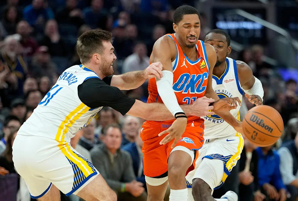 SAN FRANCISCO, CALIFORNIA - DECEMBER 02: Aaron Wiggins #21 of the Oklahoma City Thunder driving to the basket gets fouled by Pat Spencer #61 of the Golden State Warriors in the second half at Chase Center on December 02, 2025 in San Francisco, California. NOTE TO USER: User expressly acknowledges and agrees that, by downloading and or using this photograph, User is consenting to the terms and conditions of the Getty Images License Agreement. (Photo by Thearon W. Henderson/Getty Images)